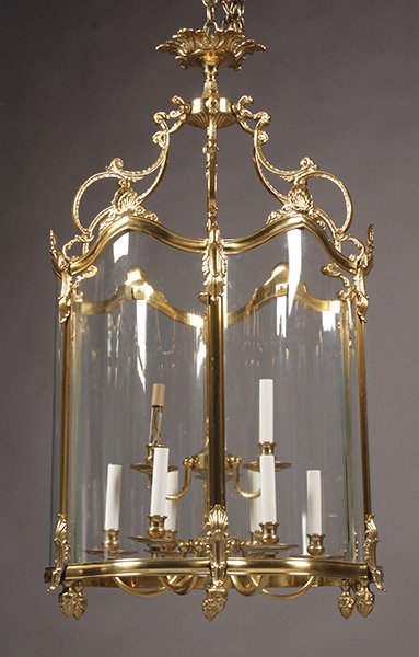 BRONZE LOUIS XV STYLE HANGING LIGHT FIXTURE: Large bronze Louis XV style hanging light with an ornate crown supported six sided and shaped glass paneled lantern with interior nine light fixture. Ht: 31" Width: 32" Depth: 32"
