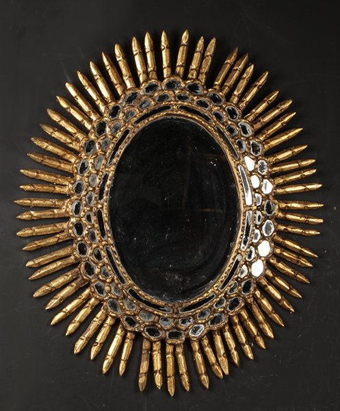GILT WOOD OVAL SUNBURST MIRROR C.1950: A gilt wood oval form sunburst mirror having tiered mirror border circa 1950. Ht: 27" Width: 31"