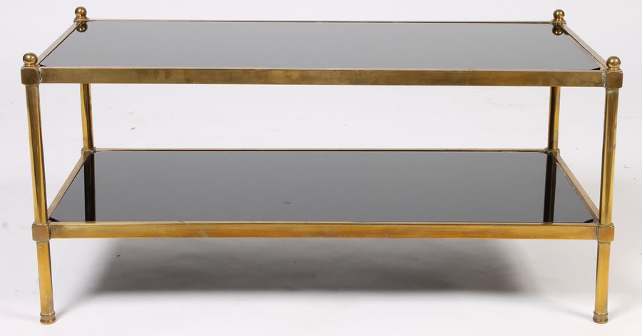 BRONZE 2 TIER BLACK GLASS COFFEE TABLE: Bronze two-tier coffee table with black glass and ball finials circa 1970. Ht: 17" Width: 36" Depth: 18"
