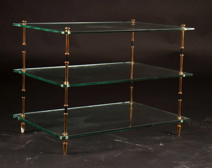 FRENCH BRONZE SIDE TABLE W/ 3 GLASS TIERS C.1950: A French bronze side table having three glass tiers supported on turned corner supports, circa 1950. Ht: 18.5" Width: 25.5" Depth: 16.5"