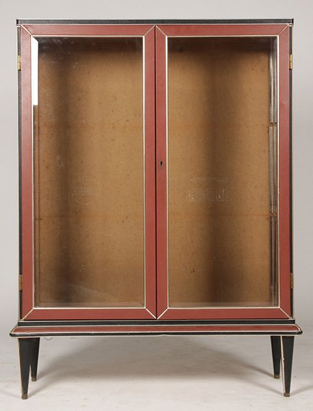 ITALIAN VITRINE FAUX LEATHER NICKEL TRIMMED CASE: A stylish Italian vitrine having two tone faux leather wrapped and nickel trimmed case with two beveled glass front doors and sides circa 1940. Case also has one glass shelf and is raised on tapered l