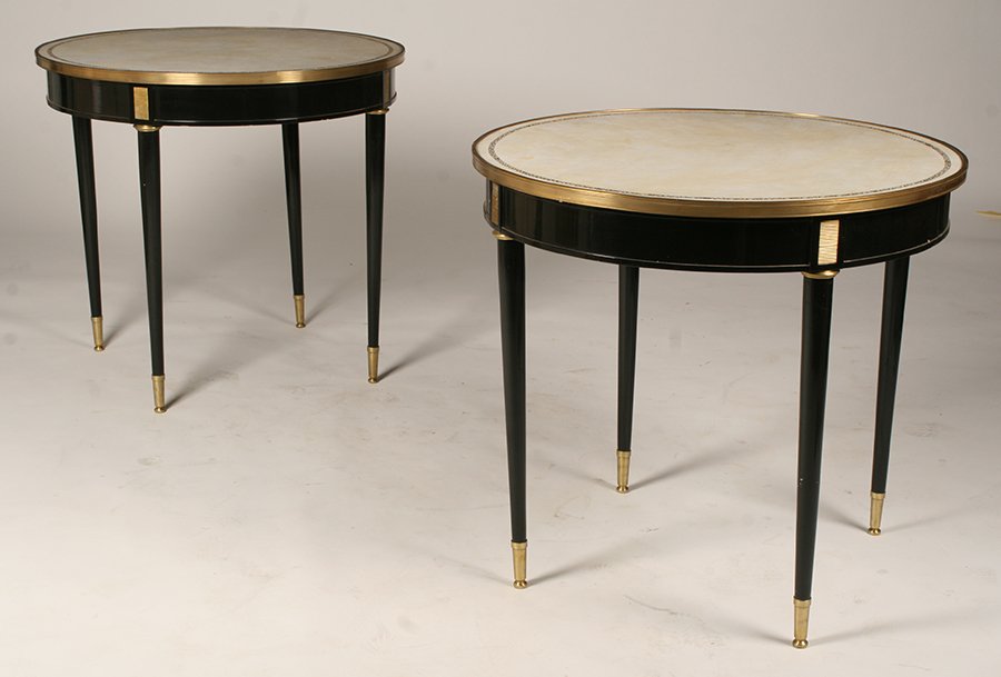 PAIR DIRECTOIRE STYLE EBONIZED GUERIDONS LEATHER: A pair of Directoire style ebonized gueridons having leather tops with bronze trim supported on bronze mounted turned legs with sabots. Ht: 29.5" Dia: 31"