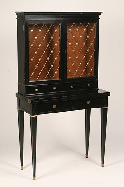 JANSEN REGENCY STYLE EBONIZED BOOKCASE & DESK: A good Jansen Regency style ebonized bookcase and desk circa 1940. Having two glass front doors with bronze diamond form grills over flip top desk and two drawers supported on tapered legs. Ht: 64" Wi