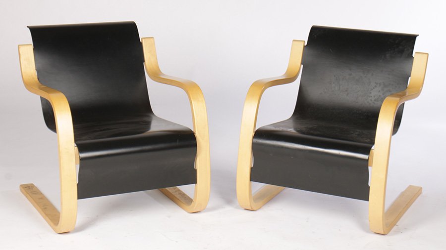 PAIR LABELED ICF MODERN PLYWOOD LOUNGE CHAIRS: A pair of labeled ICF modern bent plywood lounge chairs having ebonized seats and open arms. Ht: 28" Width: 24" Depth: 28"