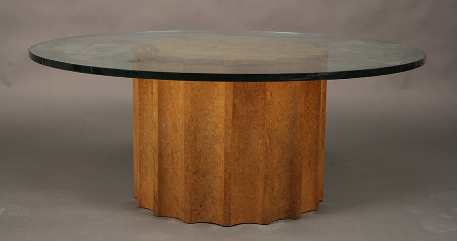 MILO BAUGHMAN STYLE BURLED WALNUT COFFEE TABLE: A Milo Baughman style burled walnut coffee table having glass top supported by fluted gear form pedestal base circa 1960. Ht: 16.5" Dia: 42"