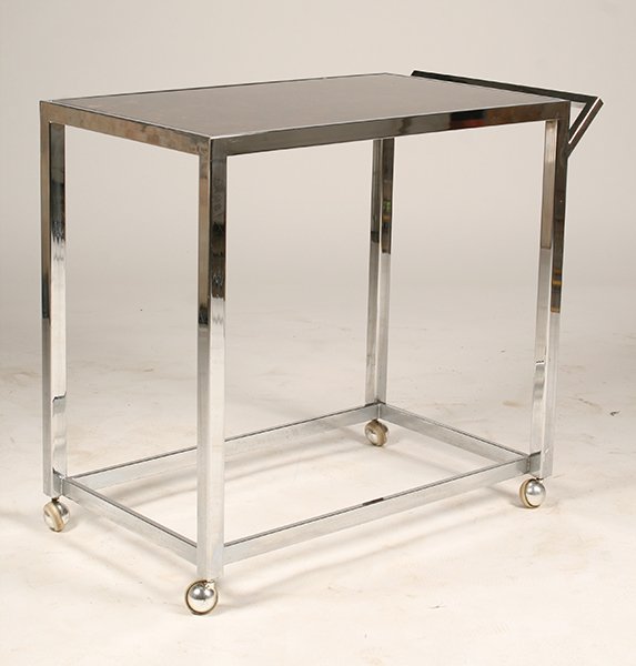 MID CENTURY MODERN CHROME SERVING CART: A mid century modern chrome serving cart having inset stone top and extended handle raised on casters circa 1970. Ht: 30" Width: 34.5" Depth: 19"