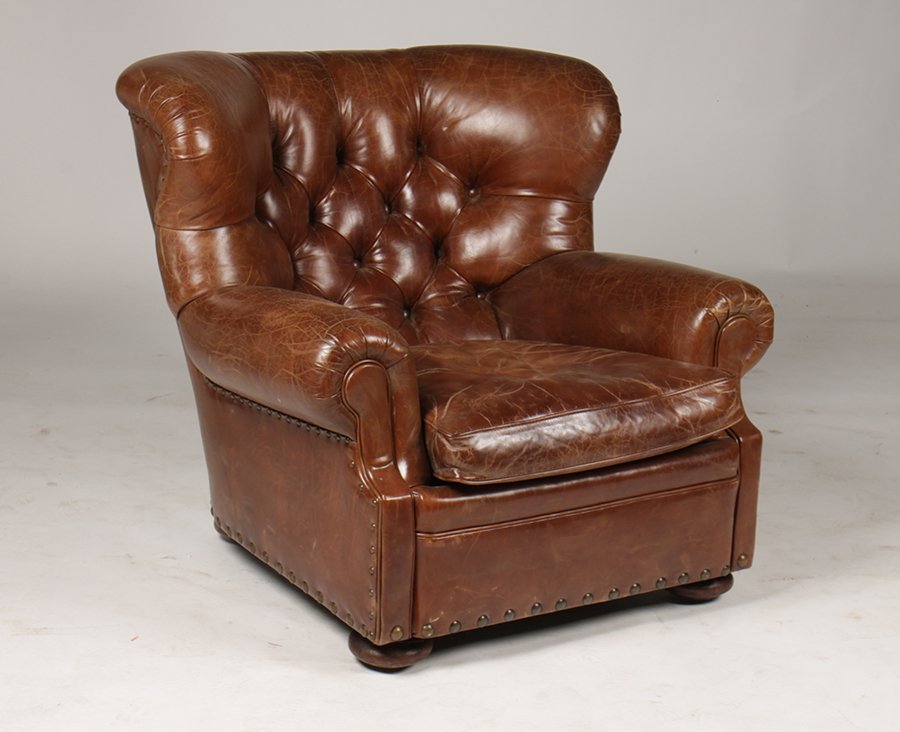 LABELED RALPH LAUREN LEATHER CLUB CHAIR: A labeled Ralph Lauren leather club chair having a tufted back on loose cushion seat all raised on bun feet. Ht: 36" Width: 39" Depth: 30"