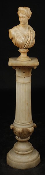 BUST DIANA ALABASTER PEDESTAL ACANTHUS C.1900: A carved alabaster bust of Diana resting on alabaster pedestal with acanthus leaf and flute decoration circa 1900. All raised on stepped base Ht: 59.5" Width: 11" Depth: 11