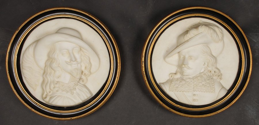 FRAMED PAIR CARVED MARBLE PONCE DE LION PLAQUES: A framed pair of heavily carved marble "Ponce de Leon" figural plaques circa 1920. Ht: 11" Width: 11" Depth: 2"