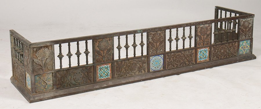 BRONZE AESTHETIC MOVEMENT FIREPLACE FENDER C.1840: A very good bronze Aesthetic Movement fireplace fender having stylized sunflower decorated panels and possibly Minton tile inserts circa 1840. Ht: 12" Width: 60" Depth: 14.5"