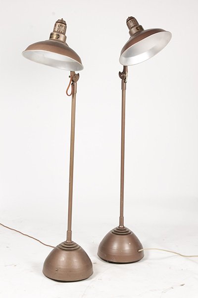 PR PAINTED METAL GENERAL ELECTRIC LAMPS C. 1940: A pair of painted metal industrial General Electric sun lamps resting on casters circa 1940. Ht: 67" Width: 15"