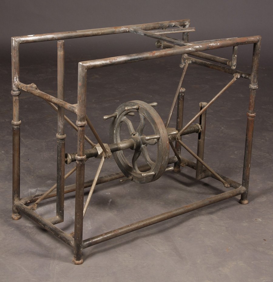 MECHANICAL ADJUSTABLE INDUSTRIAL TABLE FLY WHEEL: A mechanical adjustable industrial table with fly wheel circa 1910. Ht: Adjustable Width: 39" Depth: 19"