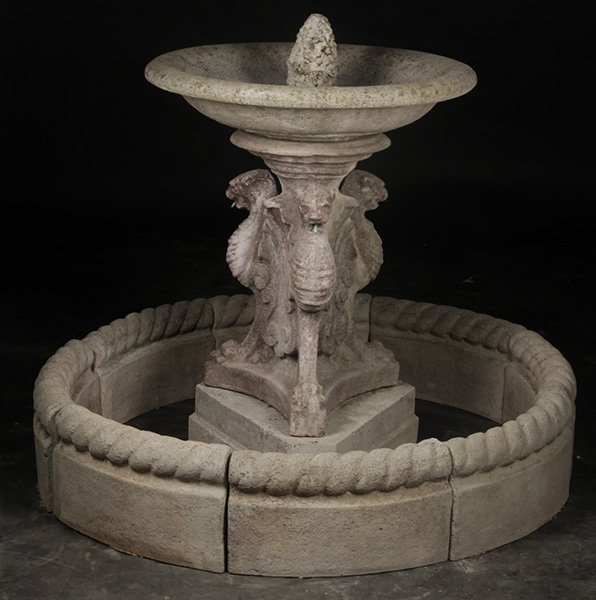 CAST STONE GARDEN FOUNTAIN 8 PC SURROUND: A cast stone garden fountain having shallow bowl supported on winged griffin and triangular plinth base along with eight piece fountain surround. Ht: 41" Dia: 28.5"