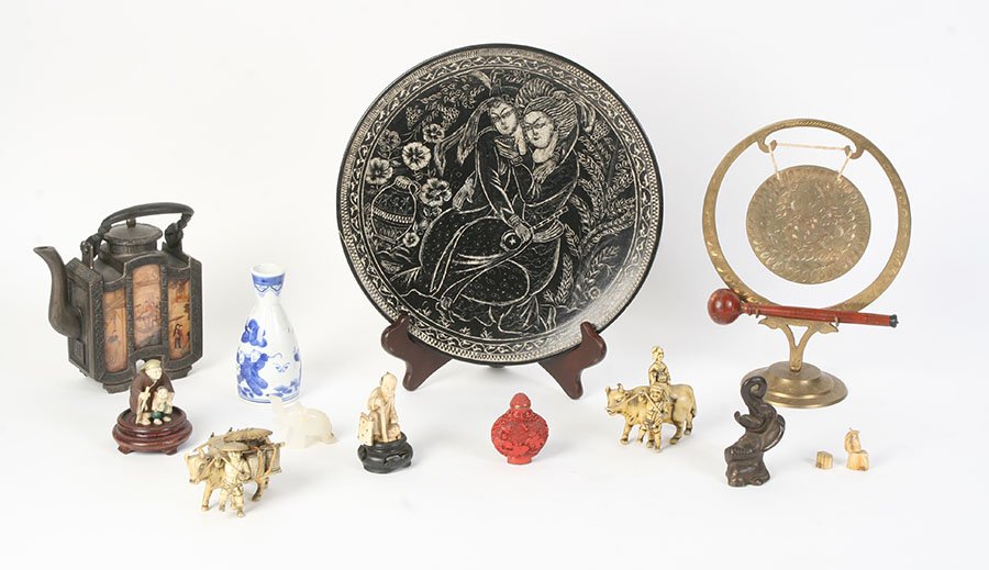 LOT OF 11 ASIAN MIXED MEDIA STONE BRONZE: An eleven piece mixed media Asian lot. Consiting of: (1) 11.5" ceramic plate with mogul motif (1) 10.25" gong (2) ivory figurines (2) resin figure groups (1) sake bottle (1) cinnabar snuff bottle (1)