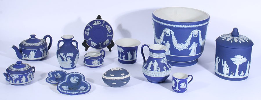 LOT OF 13 VINTAGE WEDGWOOD JASPERWARE COLLECTION: Early to mid twentieth century thirteen piece lot of vintage Wedgwood cobalt jasperwares. Consisting of: (1) Cache pot (1) Biscuit jar (1) 3-piece tea service (1) Egg box (1) Milk jug (1) Portland sty