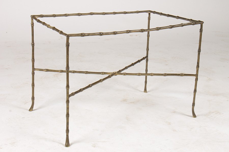 BRONZE FAUX BAMBOO SIDE TABLE WITH GLASS TOP: A bronze faux bamboo side table having glass top over X-form stretcher. Ht: 17" Width: 24" Depth: 16"