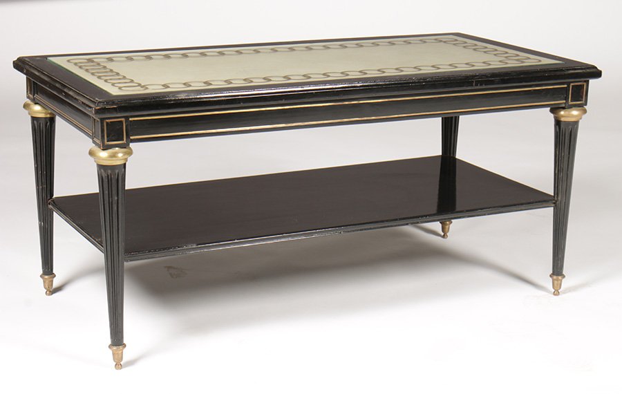 JANSEN EBONIZED TIERED COFFEE TABLE LEATHER BRONZ: Jansen ebonized two tiered coffee table in the Directoire style with inset leather top, bronze trimmed apron and fluted legs circa 1940. The glass top having an etched circular design. Ht: 18.5" Width