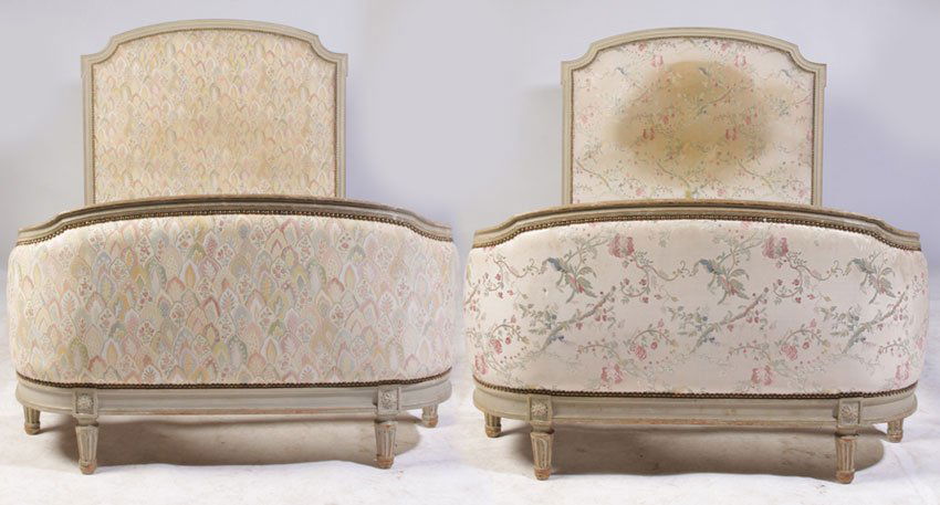 PR FRENCH LOUIS XVI STYLE CARVED PAINTED BEDS C.1940: A pair of French Louis XVI style carved and painted beds having upholstered footboard and headboard circa 1940. Both headboard and footboard having nailhead trim, all raised on turned and fluted legs.