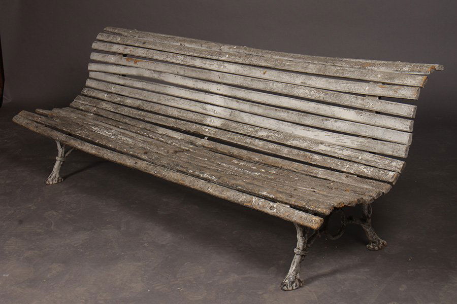 CAST IRON WOOD GARDEN BENCH ROLLED BACK: A cast iron and wood garden bench with rolled back and seat circa 1910. Ht: 29" Width: 84" Depth: 26"