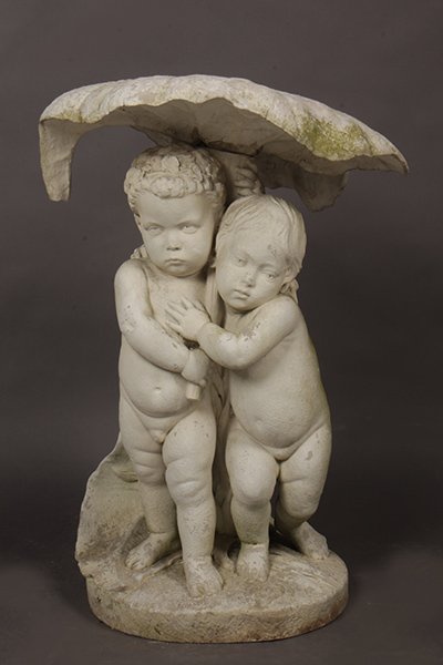 CARVED AND MARBLE BIRD BATH W/ CHERUBS: A carved marble sculpture having a leaf form decoration supported by two cherubs standing on naturalistic base. Ht: 42" Width: 22" Depth: 17"