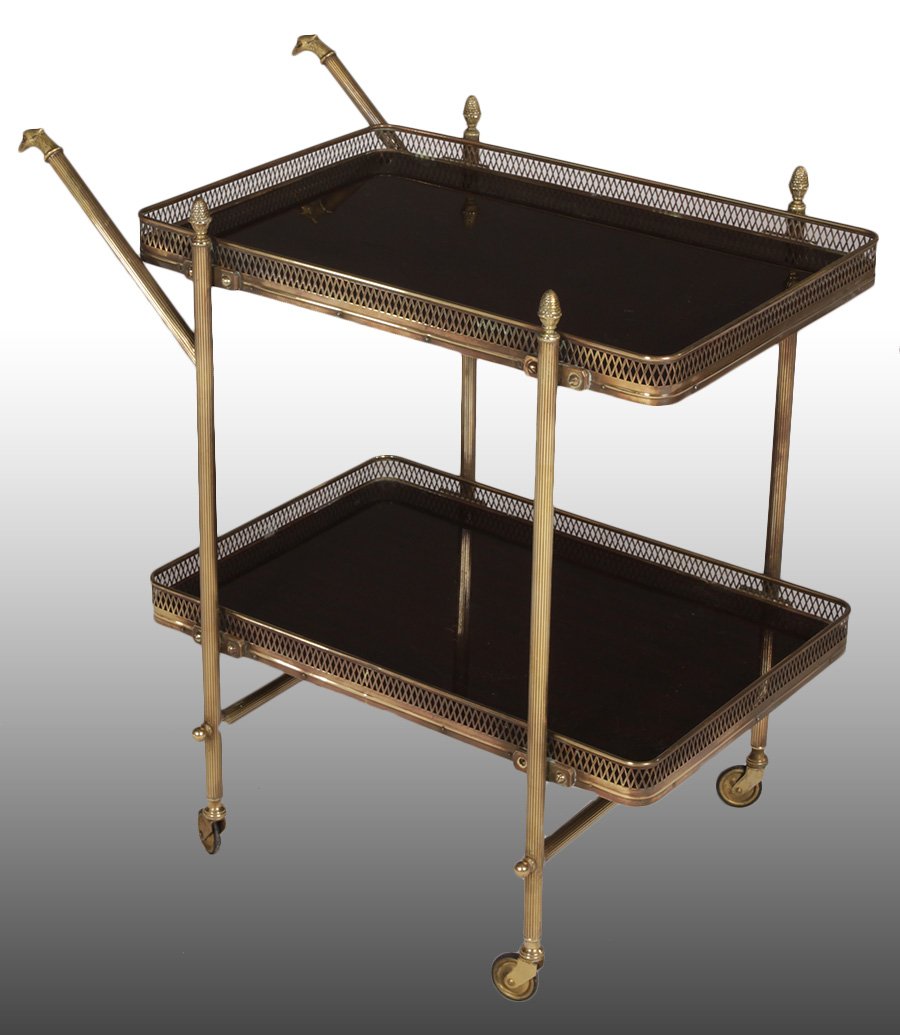 EMPIRE STYLE MAHOGANY SERVING CART C. 1960: Empire style bronze and mahogany two tiered bar cart having eagle handles and pierce decorated galleries raised on casters circa 1960. Ht: 29" Width: 29" Depth: 18"