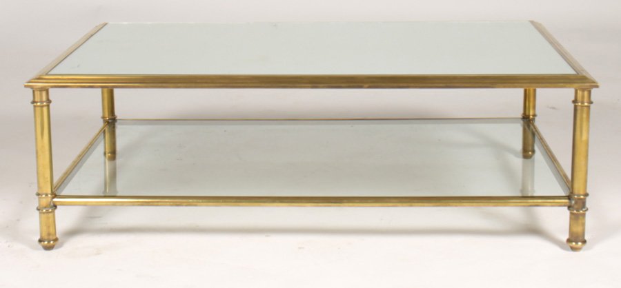 BRONZE COFFEE TABLE INSET MIRROR TOP C.1940: Elegant bronze coffee table having inset mirror top framed by stepped edge circa 1940. Supported on corner columns and box stretcher with glass shelf. Ht: 14" Width: 43" Depth: 28"