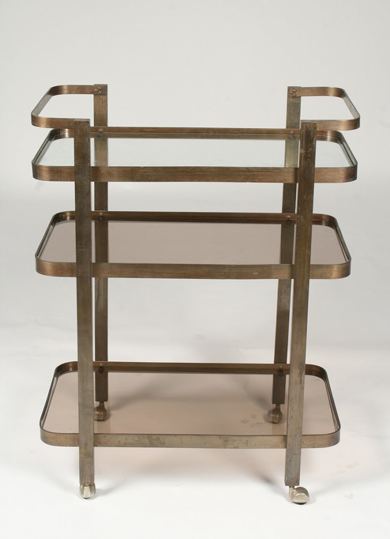 MODERN BRONZE SERVING CART 3 GLASS SHELVES 1970: Interesting mid century modern bronze serving cart having three glass tiered shelves, raised on casters circa 1970. Ht: 40" Width: 31.5" Depth: 19.5"