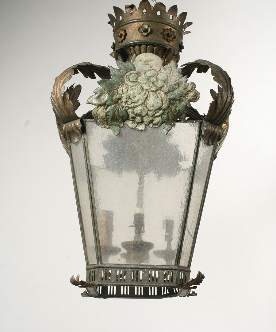 19TH C. ITALIAN GILT POLYCHROME TOLE LANTERN: Nineteenth century Italian gilt and polychrome decorated tole lantern. The pierced corona above scrolled leaves, the tapering octagonal glazed body with floral clusters and scrolled feet. Ht: 24" Widt