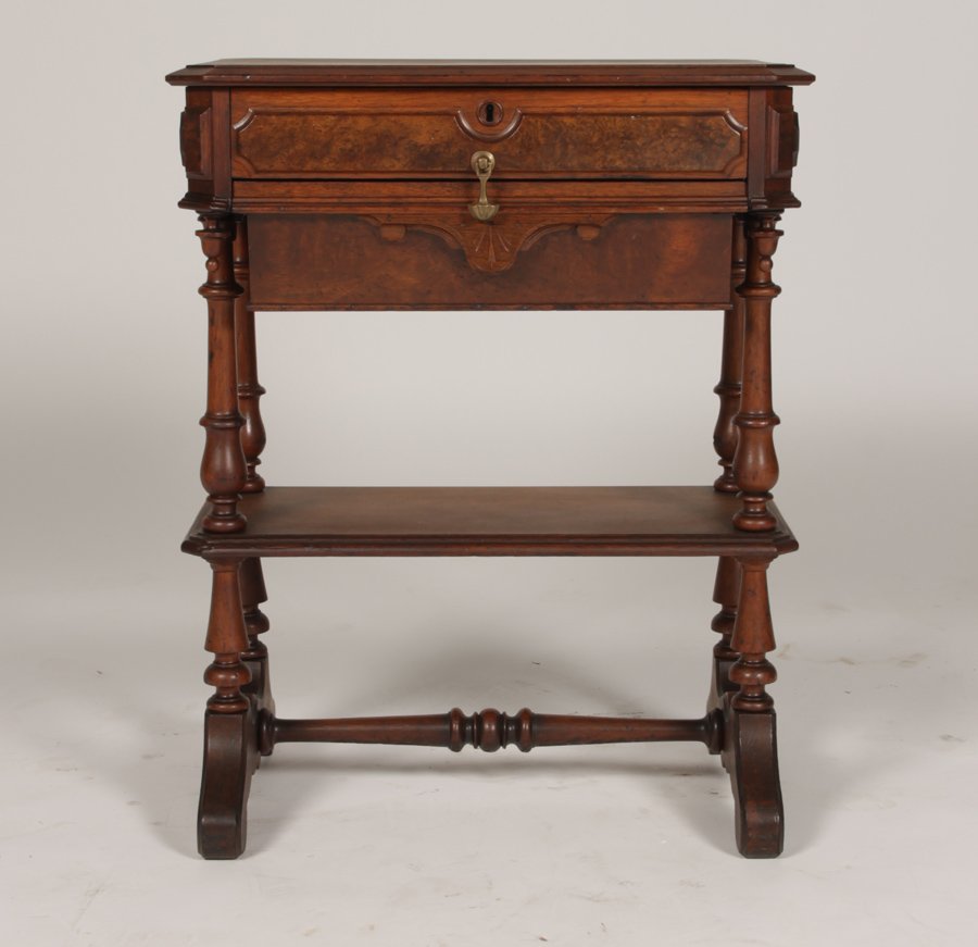 AMER. VICT. WALNUT SEWING TABLE SHAPED TOP 1870: American Victorian walnut sewing table having shaped top over single burl front drawer and slide out tray above lower tier shelf circa 1870. Supported on turned legs. Ht: 30" Width: 24" Depth: 16.5"