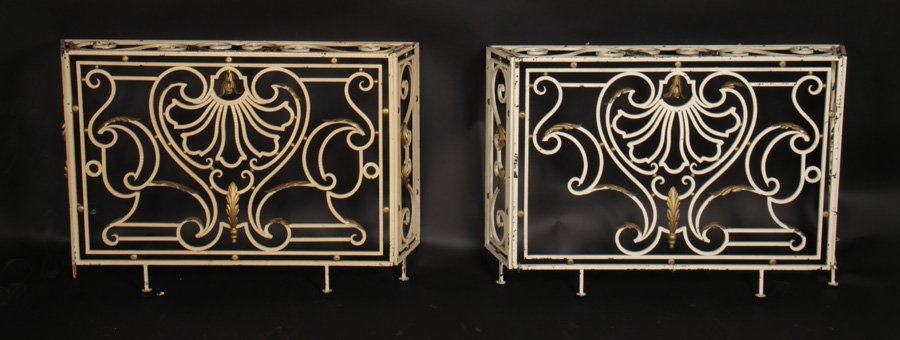PAIR PAINTED IRON FRENCH CONSOLE TABLES: A matched pair of French cast iron console tables with central cartouche and scrolling decoration circa 1920. Ht: 35" Width: 49" Depth: 10"