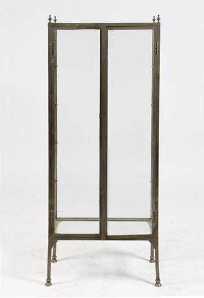 BRONZE VITRINE 4 FINIALS GLASS SHELVES: A well proportioned nickel over bronze vitrine having four finials resting on a case that houses four glass shelves circa 1940. Ht: 67" Width: 28" Depth: 14"