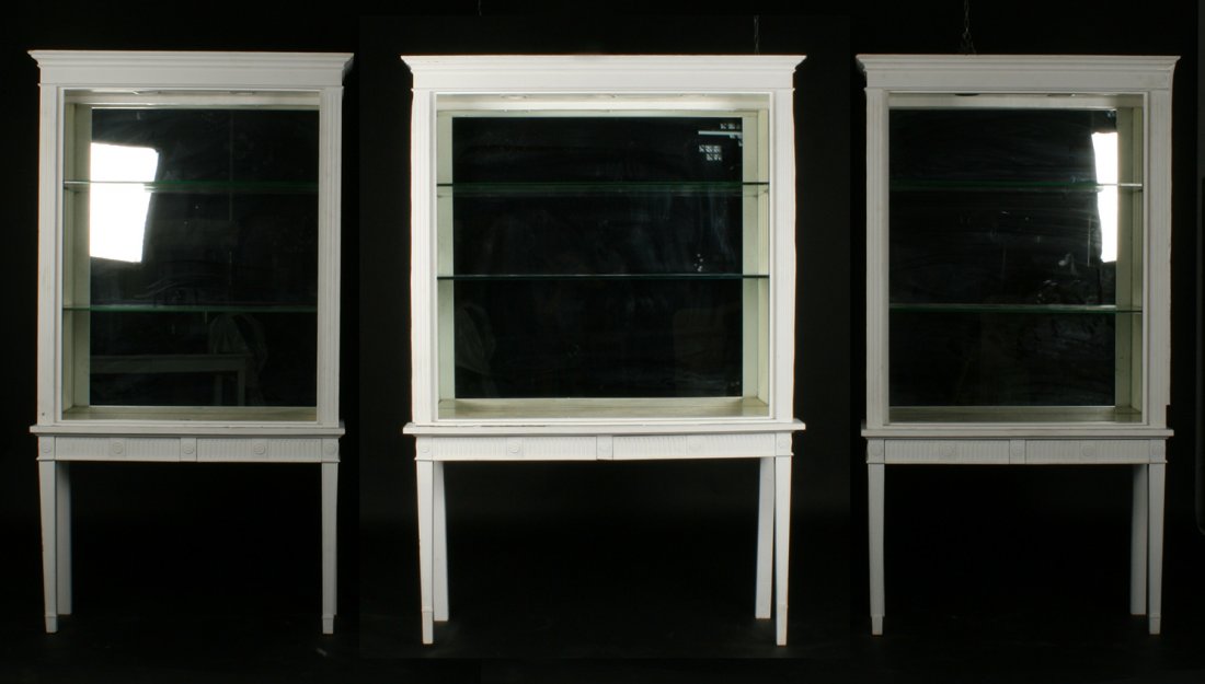 3 GEORGIAN PAINTED 2 PART VITRINE DISPLAY CABINET: Thee Georgian style painted two part vitrine or display cabinets having stepped cornice and fluted pilasters. All supported by lower console with tapered legs. Ht: 82.5" Width: 44" Depth: 10"