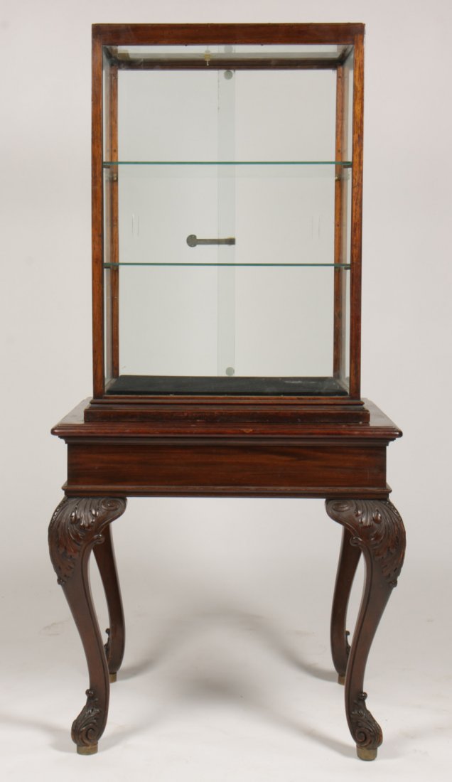 CARVED MAHOGANY DISPLAY CASE HALE & KILBURN 1890: Two-part carved mahogany display case labeled Hale and Kilburn (Philadelphia) circa 1890. Having two sliding glass doors and carved cabriole legs.Dimensions: 65.5"H x 31" W x 27"D