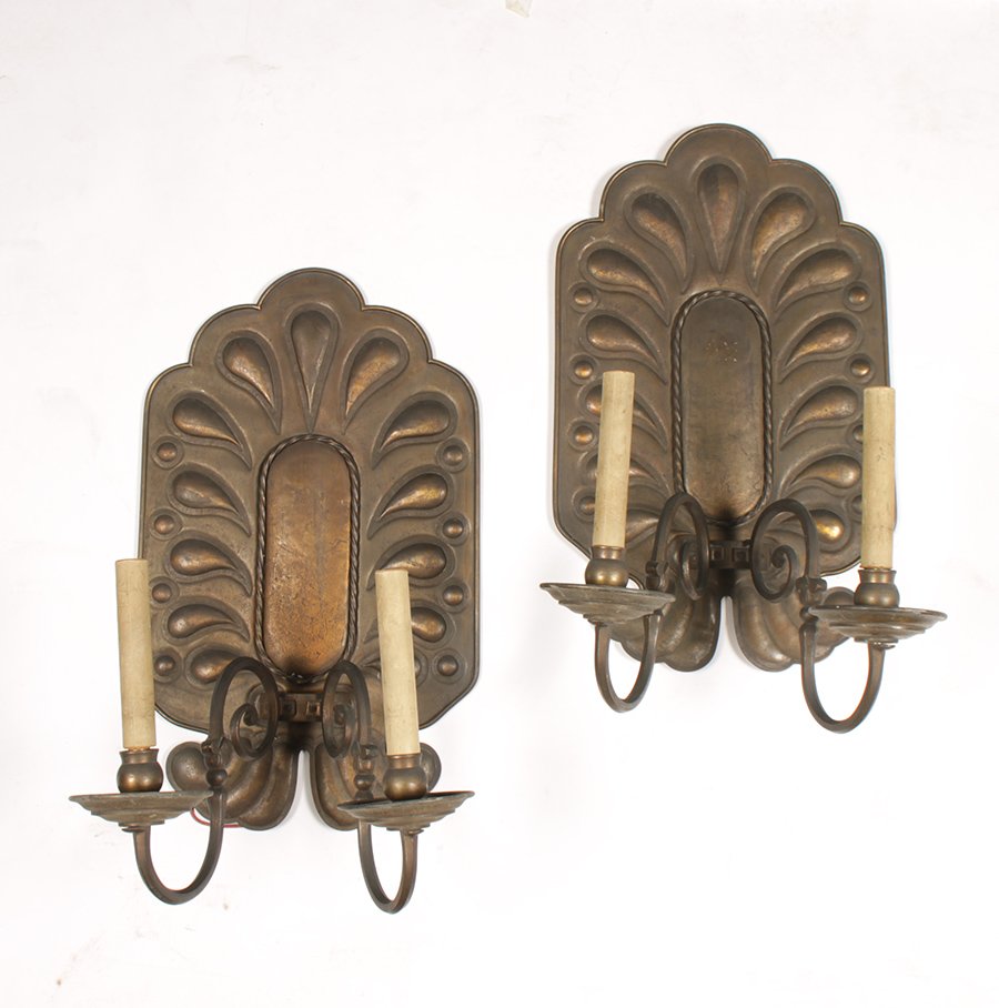 PR CONTINENTAL TOLE BRASS SCONCES CIRCA 1910: Pair of Continental tole brass sconces having over sealed back plate with stylized relief decoration supporting two scrolling arms circa 1910. Ht: 21" Width: 12" Depth: 9.5"