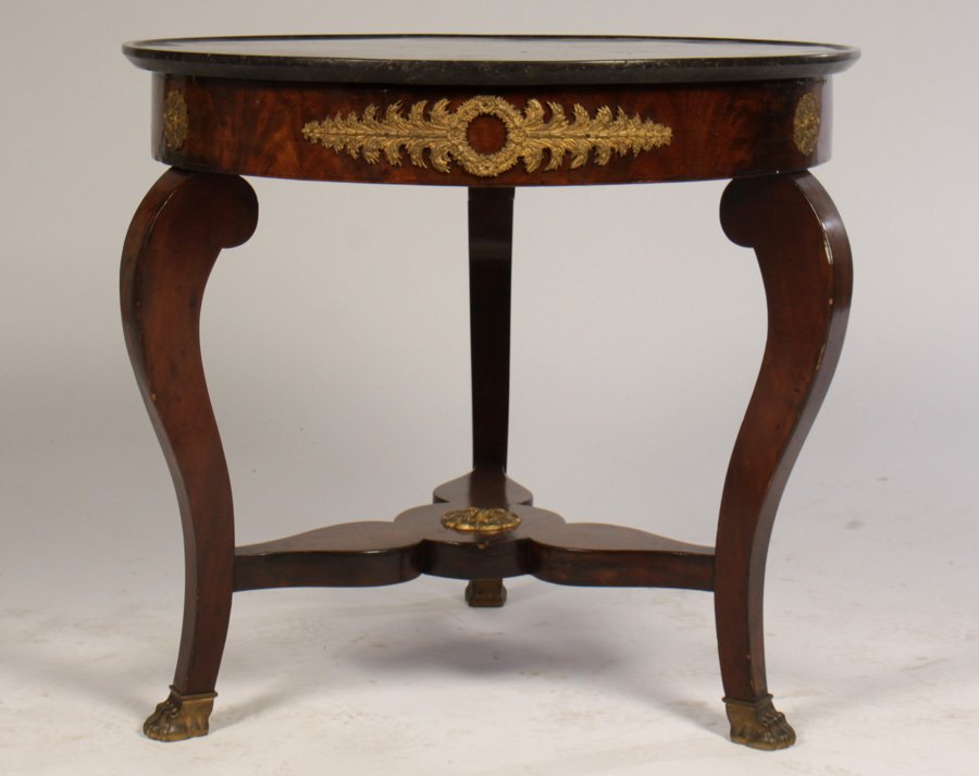 19TH C. EMPIRE CENTER TABLE MARBLE TRAY TOP: A French nineteenth century Empire center table having marble tray top over bronze mounted apron supported on cabriole legs. The shaped stretcher having central bronze roundel. Ht: 29" Dia: 32"