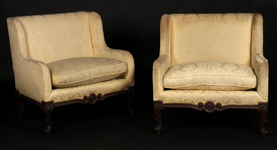 PR L. 16 UPHOLSTERED SETTEES LOOSE CUSHIONS 1920: A pair of Louis XVI style upholstered settees having winged backs over loose cushion seats circa 1920. All raised on carved mahogany back with gadrooned edge and cabriole legs. Ht: 39" Width: 38" Dept