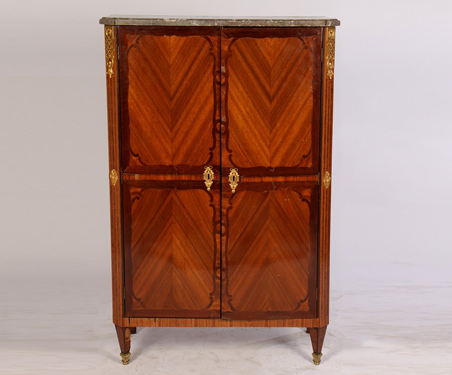 19TH CENT. FRENCH LOUIS XVI CABINET MARBLE TOP: A good nineteenth century French Louis XVI style cabinet having marble top over two inlaid doors with shaped banding framing chevron panels. Raised on tapered legs with bronze sabots. Ht: 56" Width: 3
