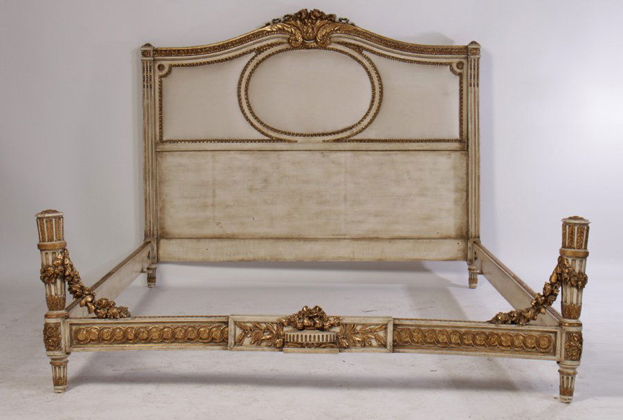 REGENCY STYLE CARVED PAINTED QUEEN SIZE BED 1940: A Regency style giltwood carved and painted Queen size bed having central carved cartouche over upholstered paneled headboard circa 1940. The headboard flanked by fluted columns and a similar carved a