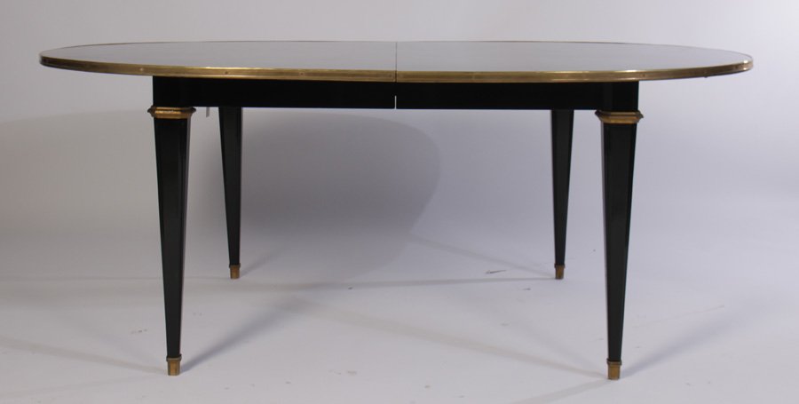 JANSEN STYLE EBONIZED DINING TABLE 1 LEAF 1940: A very good Jansen Louis XVI style ebonized dining table having bronze trimmed top circa 1940. Supported on chamfered and tapered legs with bronze sabots. Having one leaf measuring 24". Ht: 30.5" Widt
