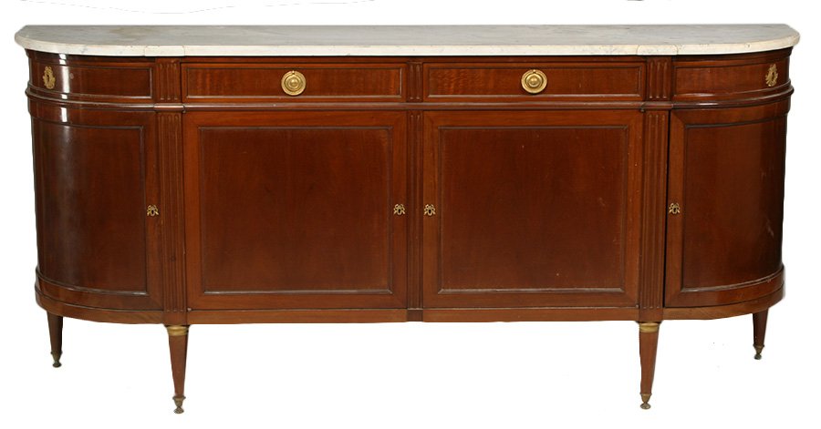 DIRECTOIRE MAHOGANY SIDEBOARD MARBLE TOP C.1920: A Directoire style mahogany sideboard having shaped marble top over four drawers and four paneled doors circa 1920. Raised on bronze mounted turned and tapered legs with sabots. Ht: 38.5" Width: 82" D