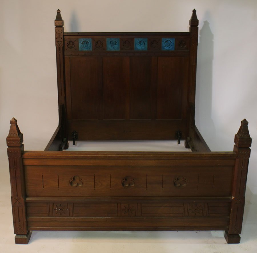 AMER. VICT GOTHIC WALNUT BED INCISED CARVED 1875: An American Victorian modern Gothic walnut bed having inset tiles and incised carved details circa 1875. Ht: 66" Width: 59.75" Depth: 76"