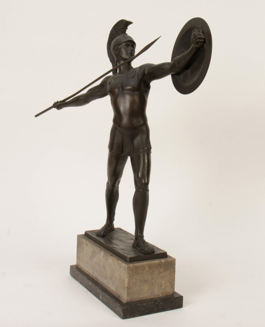 BRONZE SCULPTURE ANCIENT WARRIOR SIGNED 1910: A bronze sculpture of an ancient warrior with plummed helmet, shield and spear signed 'H.Rieder' on a stepped stone pedestal circa 1910. Ht: 19" Width: 17" Depth: 4.5"