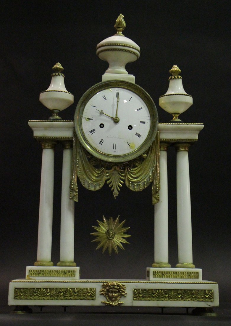 WHITE MARBLE BRONZE MANTLE CLOCK SIGNED 1840: A white marble and bronze Empire mantle clock having a silk thread suspension and swag ormolu decoration signed 'Levol A Paris' circa 1840. Having starburst figural pendulum. Ht: 25" Width: 16" Depth: