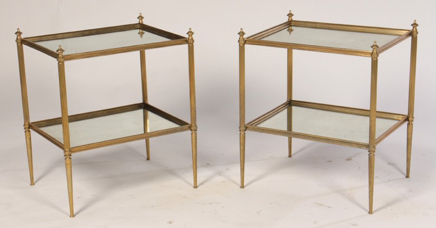 PAIR DIRECTOIRE GLAS 2-TIER END TABLES C.1945: A pair of Directoire style brass two-tier tables with mirrored shelves and turned finials circa 1945.Ht: 23" Width: 19" Depth: 15"