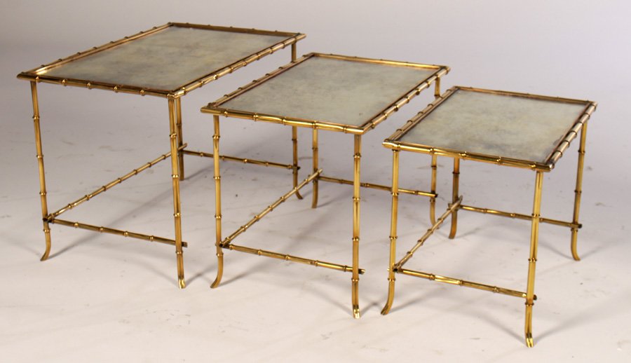 SET 3 BAGUES FAUX BAMBOO NESTING TABLES 1940: A set of three Bagues bronze faux bamboo nesting tables having distressed mirrored tops circa 1940. Ht: 16" Width: 22.5" Depth: 14"