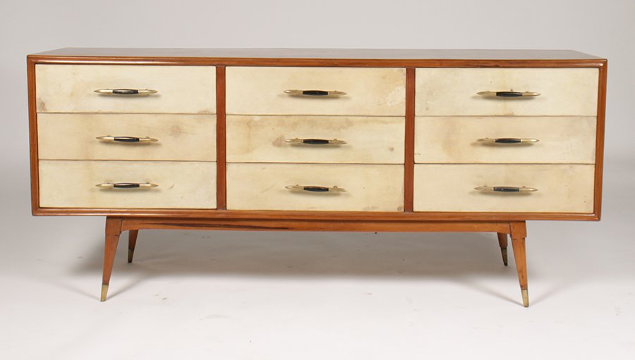 MID CENTURY MODERN W/ 9 PARCHMENT DRAWERS C.1960: Mid century modern credenza having nine parchment front drawers supported on turned and tapering legs circa 1960. Ht: 28" Depth: 63" Dia: 16"