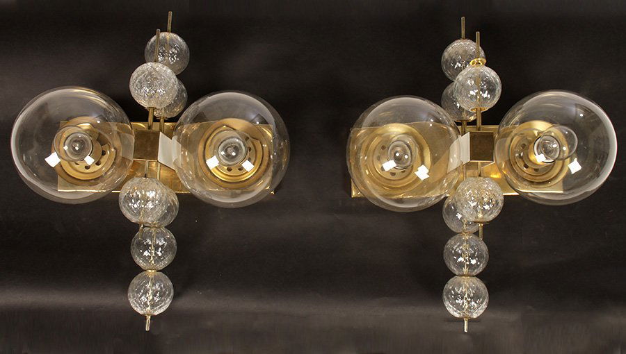 RARE AND UNUSUAL BRASS & GLASS WALL SCONCES C. 1970: A rare and unusual pair of brass and glass wall sconces circa 1970.The brass backplates supporting two large glass domes each housing one light socket. These two domes segmented by seven textured glas