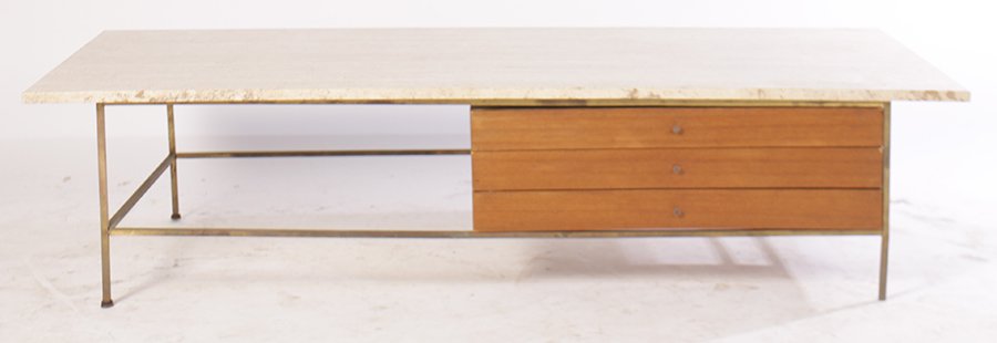 PAUL MCCOBB FOR CALVIN COFFEE TABLE 1950: A 'Paul McCobb for Calvin' coffee table having travertine top over three drawers supported on brass legs circa 1950. Ht: 16" Width: 66" Depth: 32"