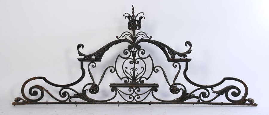 FORGED WROUGHT IRON TRANSOME 1890: A forged and wrought iron transome with stylized foliage, and central cartouche circa 1890. Ht: 41" Width: 97"