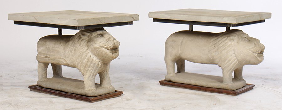 PAIR CARVED STONE LION END TABLES LIMESTONE 1950: A whimsical pair of carved stone stylized lion end tables having limestone tops supported on animal form bases raised on wood platforms circa 1950. Ht: 19" Width: 19" Depth: 23"